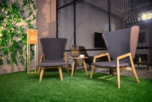 Wingback lawn chairs on artificial grass.